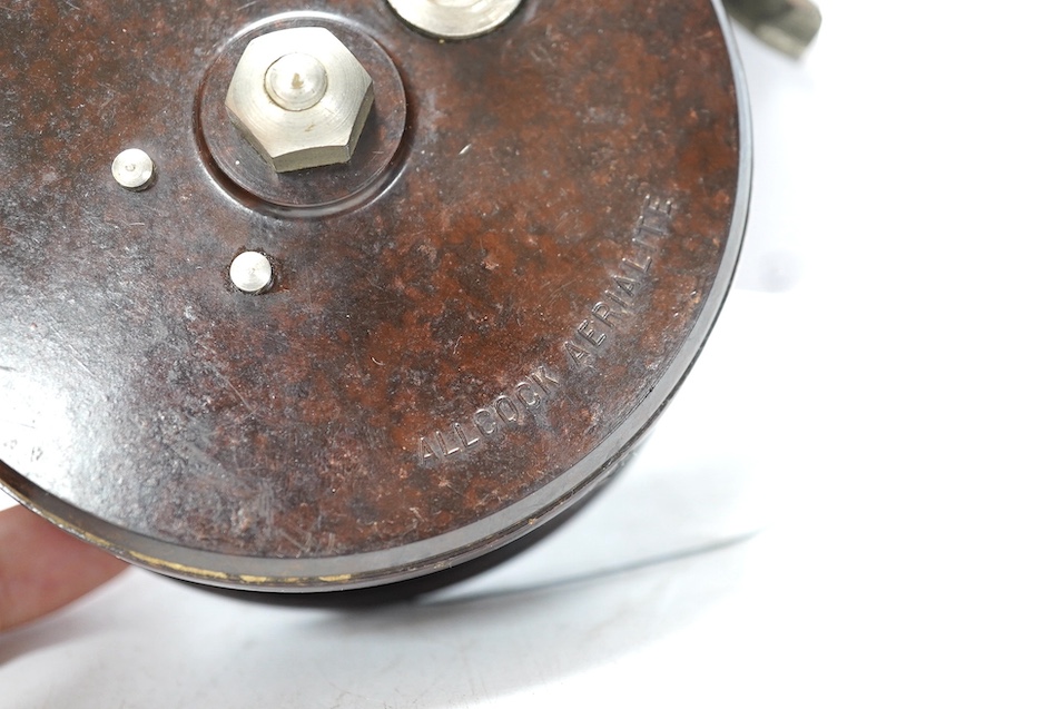 Four fishing reels, including a Bakelite Alcock Aerialite, an Elo, a Seprage C.A.P and a wooden reel, largest 10.5cm diameter. Condition - used, fair
